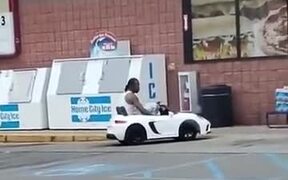 Man In A Children's Electric Car