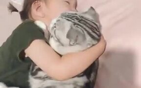 Cat Enjoying Sleeping With Little Girl