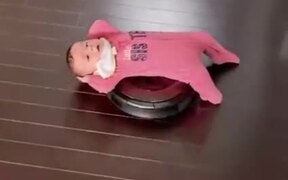 Toddler Enjoying A Ride On A Vacuum Cleaner