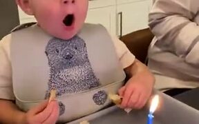 Kid Getting Frustrated To Blow Out A Candle