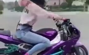 Biker Girl Performing Amazing Wheelie Stunt