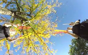 Duo Juggles Rings and Square Frames Beneath Tree - Fun - VIDEOTIME.COM