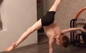 Little Boy Performs Hand Stand On One Hand