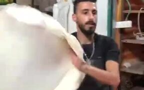 Person Demonstrates Unique Dough Tossing Skills