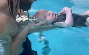 An Infant Learning To Stay Afloat - Kids - VIDEOTIME.COM