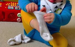 A Baby Struggles BIG TIME With Putting A Sock On 
