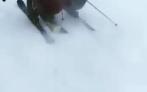 Duo Shares Ski While Skiing Downhill