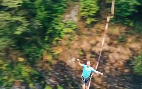 Guy Goes Slacklining Between Two Cliffs in Forest - Fun - VIDEOTIME.COM