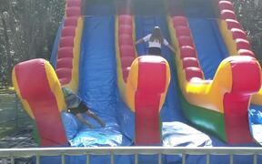 Kid Bounces Side To Side on Inflatable Slide - Kids - VIDEOTIME.COM