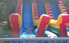 Kid Bounces Side To Side on Inflatable Slide