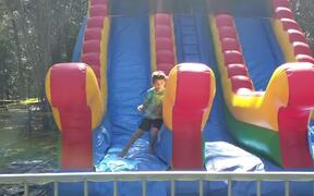 Kid Bounces Side To Side on Inflatable Slide