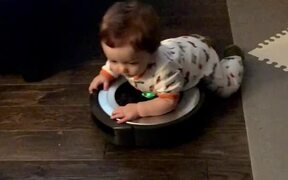 Little Boy Lays on Robot Vacuum Cleaner  - Kids - VIDEOTIME.COM