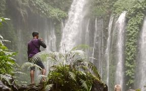 Man Vaping in Front of a Large Waterfall - Fun - VIDEOTIME.COM