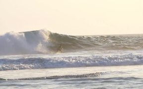 Slow Motion Shot of a Man Surfing