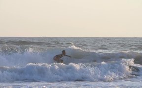Tracking Shot of a Man Surfing in the Sea - Sports - VIDEOTIME.COM