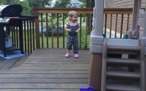 Toddler And Dog Dancing On Deck