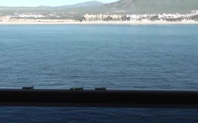 Seagull Eating Crackers On Ship Rail Boat Behind