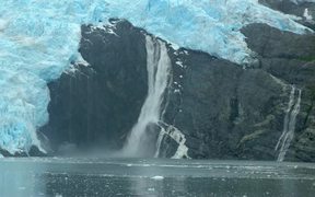 Alaska Waterfall Crashes Into Icy Waters