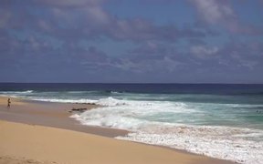 Medium Zoom Shot of Waves Crashing on Beach