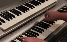 A Musician Plays a Piano and Key Board