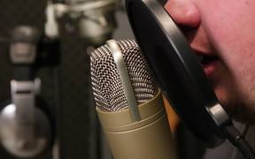 A Singer Singing in a Sound Booth Close Up
