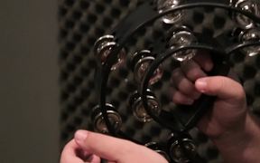 Musician Plays a Tambourine Close Up