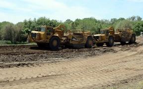 Wheel Tractor-scrapers Conducting Levee Work - Commercials - VIDEOTIME.COM