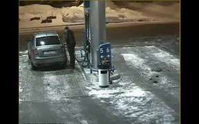 Driver Uses A Match To Look Into The Gas Tank